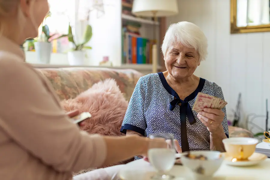 Ladies playing cards and drinking tea